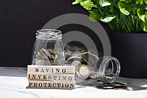 Text on wood block with Australia dollar and European coins on table surface