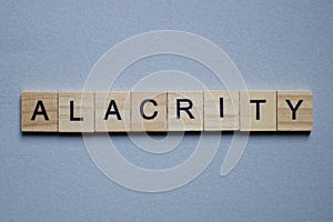 Text the word alacrity from brown wooden small letters