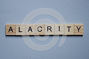 Text the word alacrity from brown wooden small letters photo