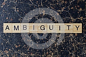 text the word ambiguity from gray wooden small letters