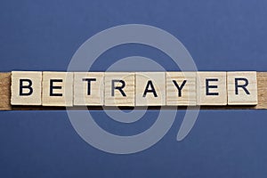 text the word betrayer from brown wooden small letters