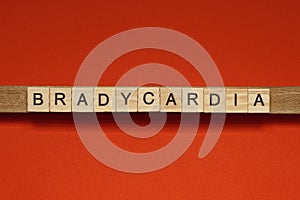 Text the word bradycardia from gray wooden small letters