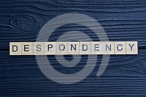 text the word despondency from brown wooden small letters