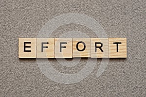 Text the word effort from brown wooden small letters