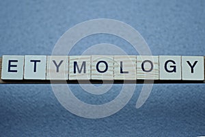 Text the word etymology from brown wooden small letters