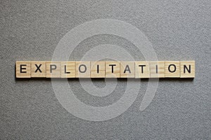 Text the word exploitation from gray wooden small letters