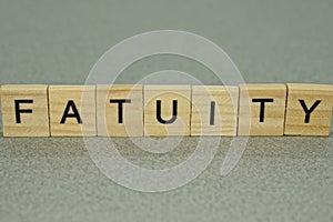 Text on word fatuity from wooden letters