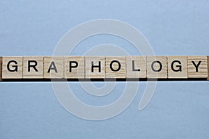 text the word graphology from brown wooden small letters