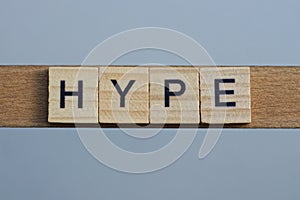 Text the word hype from brown wooden small letters