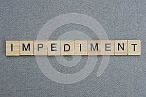 Text the word impediment from brown wooden small letters