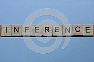 text the word inference from brown wooden small letters photo