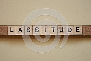 Text the word lassitude from gray wooden small letters