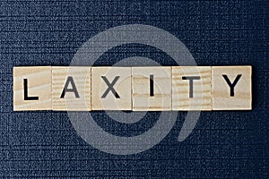 text on word laxity from gray wooden letters