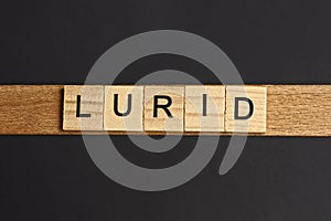 Text on word lurid from gray wooden letters