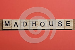 text the word madhouse from gray wooden small letters