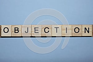 Text the word objection from brown wooden small letters
