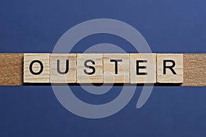 text the word ouster from brown wooden small letters