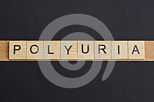 Text on word polyuria from gray wooden letters photo