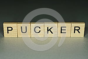 Text on word pucker from wooden letters photo