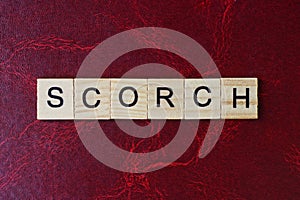 Text the word scorch from gray wooden small letters