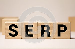 Text of the word SERP on wooden cubes on a black keyboard