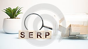 Text of the word SERP on wooden cubes on a black keyboard