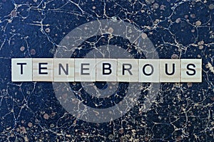 Text the word tenebrous from gray wooden small letters