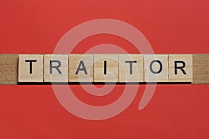 Text the word traitor from gray wooden small letters