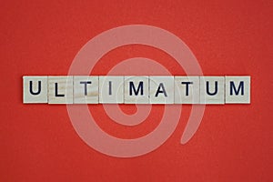 Text the word ultimatum from gray wooden small letters photo