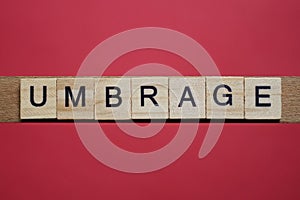 Text the word umbrage from gray wooden small letters