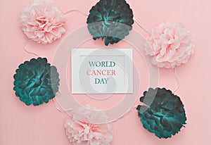 Text World Cancer Day in frame with symbolic healthy and sick flower buds