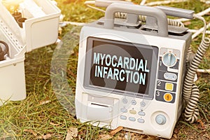 The text is written on the defibrillator monitor - MYOCARDIAL INFARCTION