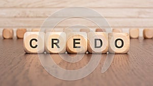 the text 'credo' is written on wooden cubes on a brown background photo