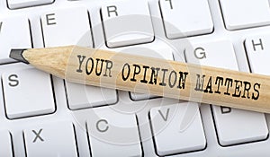 Text YOUR OPINION MATTERS on wooden pencil on white keyboard. Business concept photo