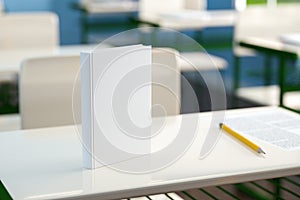 Textbook and pencil on school desk. 3d render