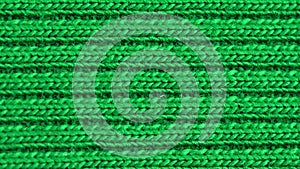 Textile background - green cotton fabric with jersey ribbing structure. Macro shoot.