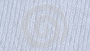 Textile background - white 100% cotton cloth with jersey stockinette structure.