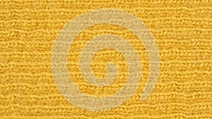 Textile background - yellow cotton fabric with jersey ribbing structure. Macro shoot.