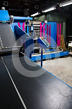 Textile fabric manufacturing machines in work.