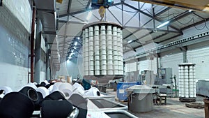 Textile factory female worker works with thread coloring machine. Modern technology in dyeing yarns with Machines for