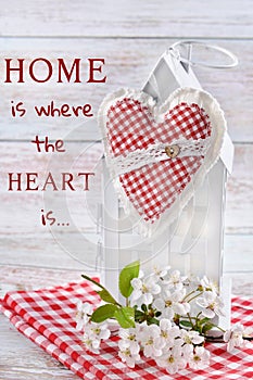 Textile heart hanging on white metal house decor and the inscription  with sentence