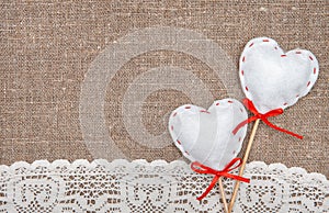 Textile hearts and lacy cloth on the burlap