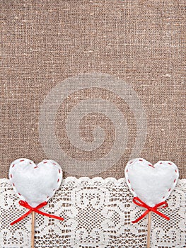 Textile hearts and lacy cloth on the burlap