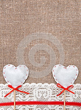 Textile hearts and lacy cloth on the burlap