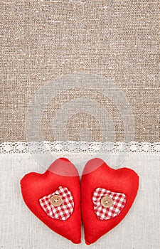 Textile hearts and linen cloth on the burlap