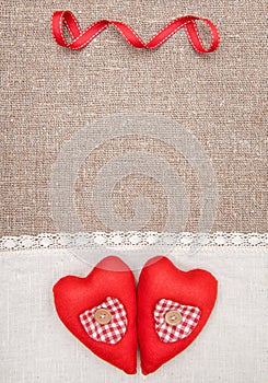 Textile hearts and linen cloth on the burlap