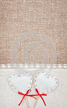 Textile hearts and linen cloth on the burlap