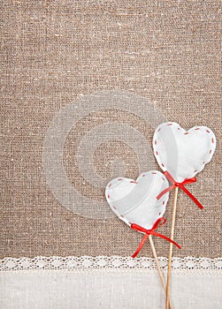 Textile hearts and linen cloth on the burlap