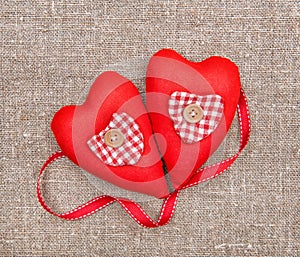 Textile hearts and ribbon on sacking