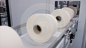 Textile Industry - Closeup shot of the yarn creel spool passing through automatic machine